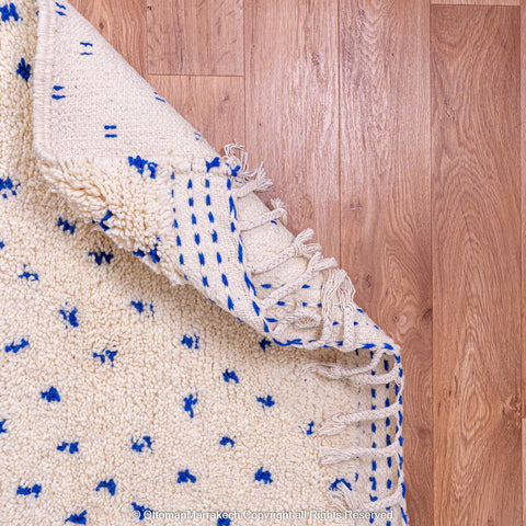 White Natural Wool Rug with Blue Dots and Embroidered Margins White Natural Wool Rug with Blue Dots and Embroidered Margins