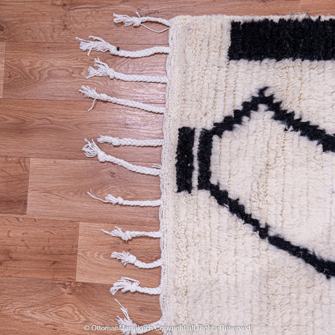 Symmetrical Black and White Berber Rug with Reversed Shapes