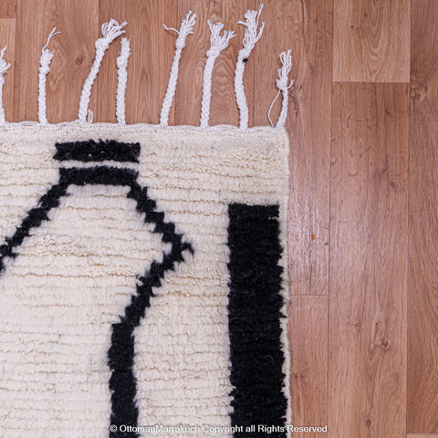 Symmetrical Black and White Berber Rug with Reversed Shapes