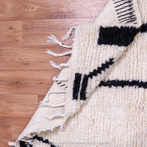 Symmetrical Black and White Berber Rug with Reversed Shapes