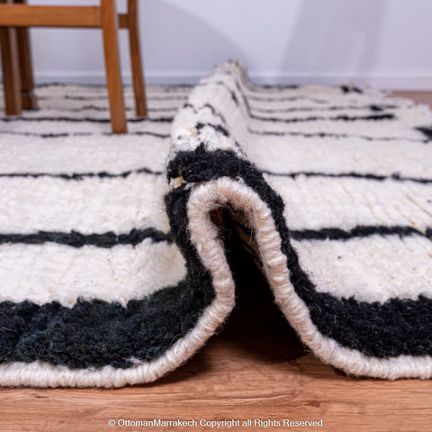 Symmetrical Black and White Berber Rug with Reversed Shapes